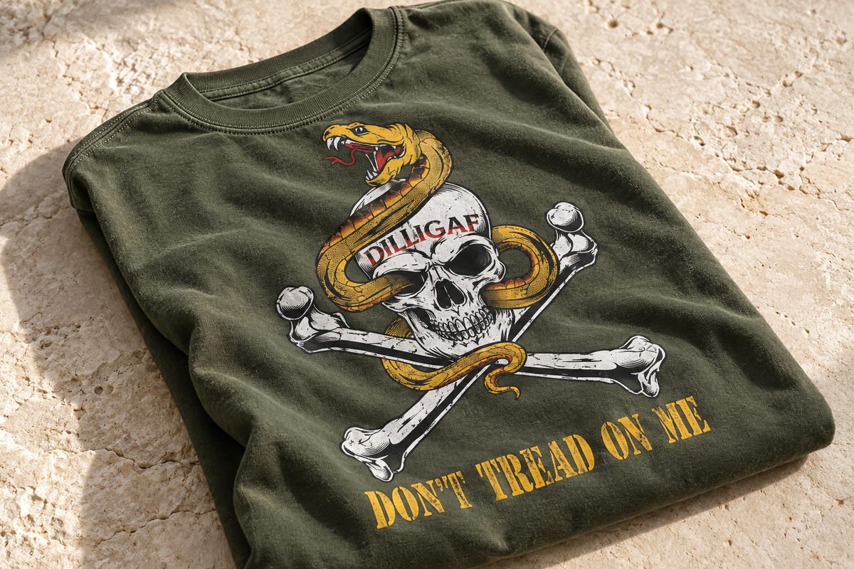 Dilligaf snake and skull print on a folded military-green shirt on pale stone